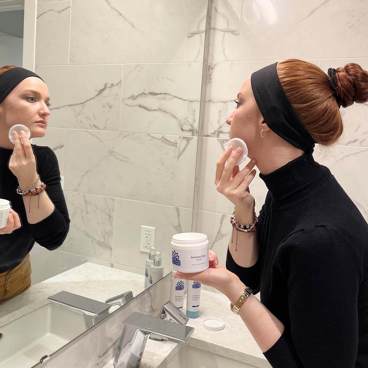 Woman cleaning her face.